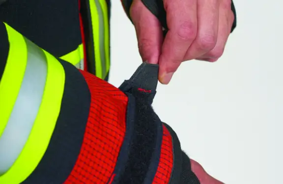 Hook and loop fastener for sleeve adjustment, a moisture barrier on the inner side and a fireretardant cuff with a thumb hole.