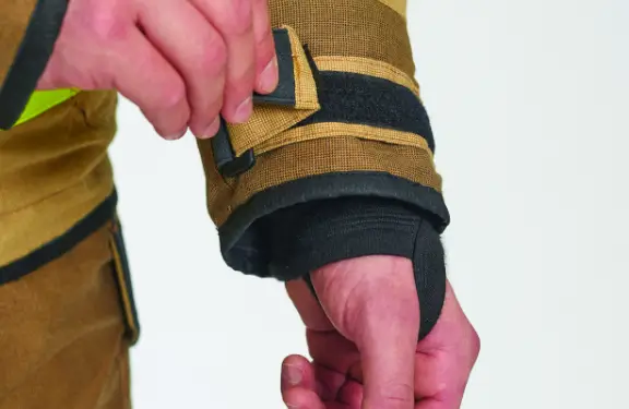 Hook and loop fastener for sleeve adjustment, a moisture barrier on the inner side and a fireretardant cuff with a thumb hole.