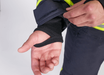 Hook and loop fastener for sleeve adjustment, a moisture barrier on the inner side and a fire-retardant cuff with a thumb hole.